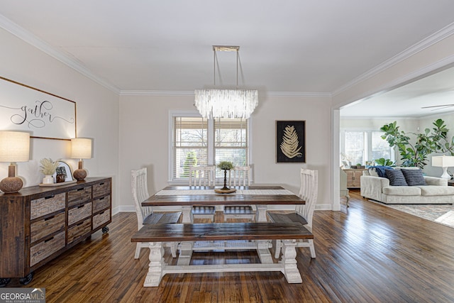 dining area featuring crown molding, dark wood-type flooring, and a notable chandelier