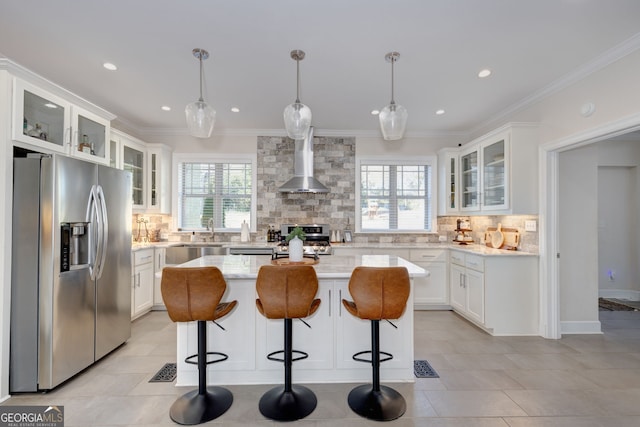 kitchen featuring white cabinets, a center island, stainless steel fridge with ice dispenser, and wall chimney range hood