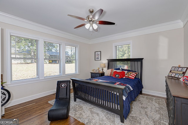 bedroom featuring hardwood / wood-style floors, ceiling fan, and ornamental molding