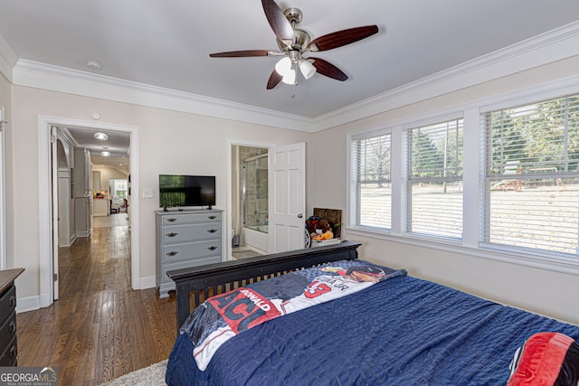 bedroom with ceiling fan, dark wood-type flooring, crown molding, and ensuite bath