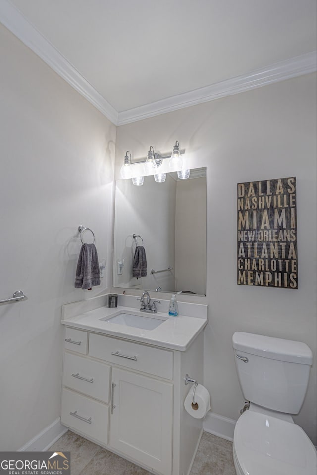 bathroom featuring tile patterned flooring, vanity, toilet, and crown molding