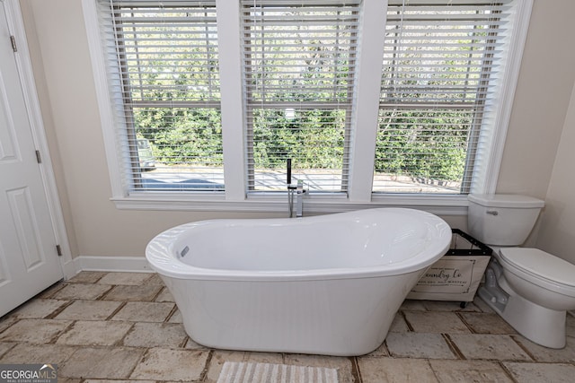 bathroom with a bath and toilet