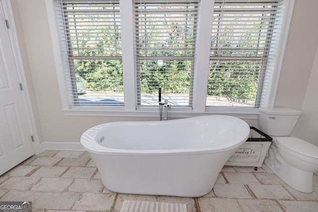 bathroom with toilet and a tub