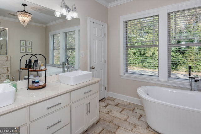 bathroom with vanity, an inviting chandelier, plenty of natural light, and ornamental molding