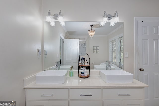 bathroom with vanity, a chandelier, and ornamental molding