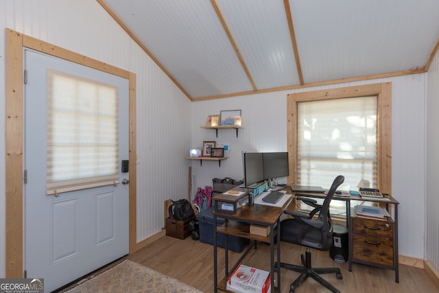 home office featuring light hardwood / wood-style flooring and lofted ceiling