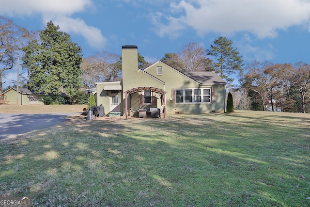 back of property featuring a lawn