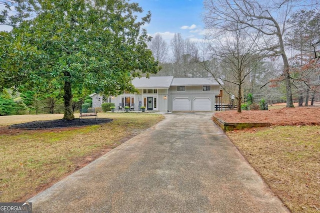 view of front of home with a garage and a front lawn