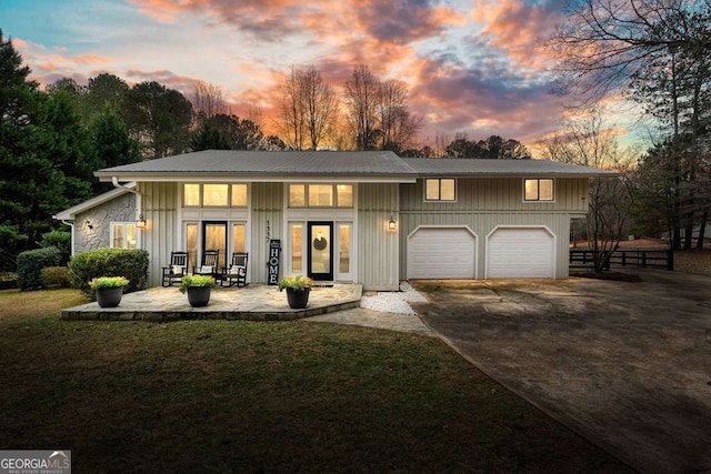 view of front of home featuring a garage and a lawn