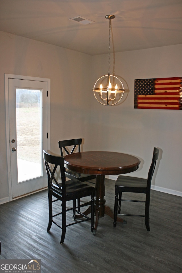 dining room featuring a notable chandelier and dark hardwood / wood-style floors