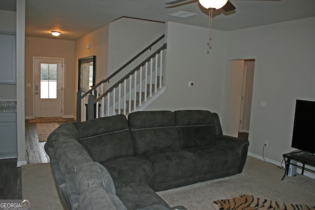 living room with ceiling fan and carpet