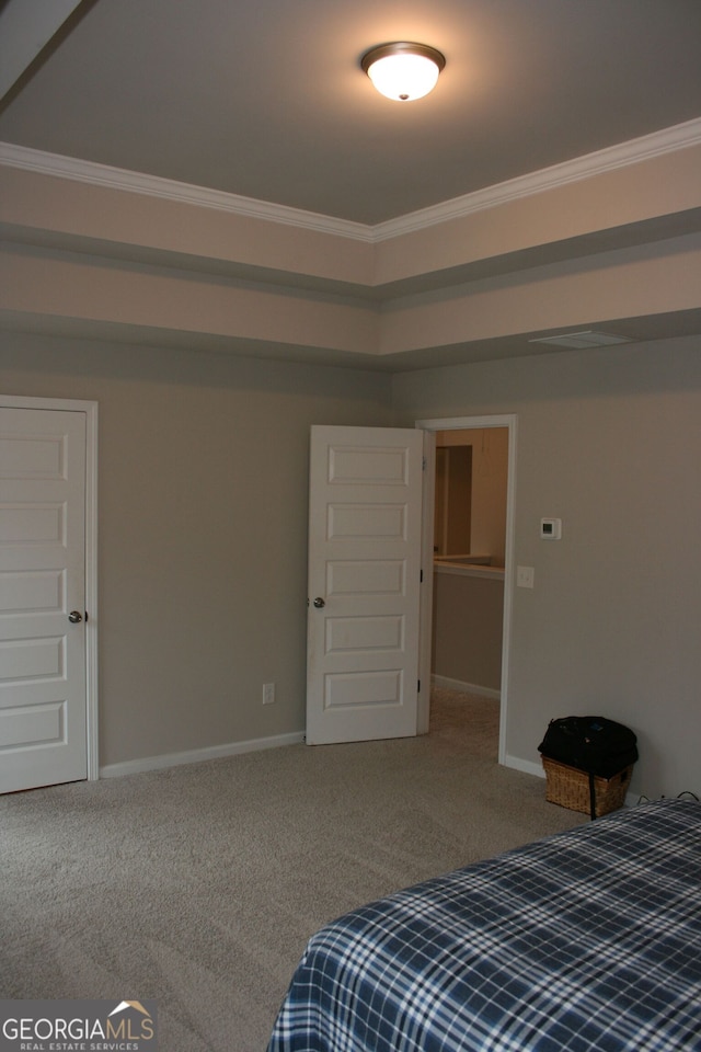 carpeted bedroom featuring a closet and crown molding