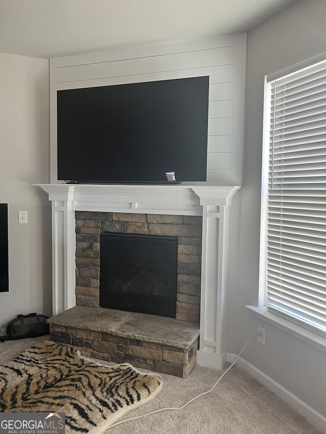 room details featuring a fireplace and carpet floors