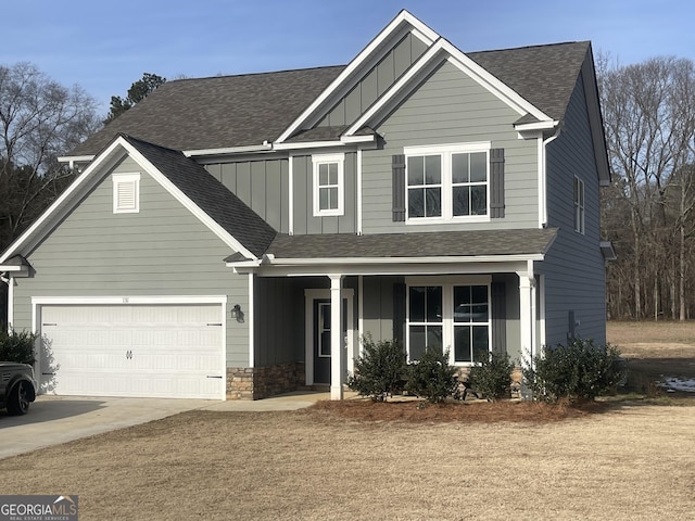 craftsman-style home featuring covered porch and a garage