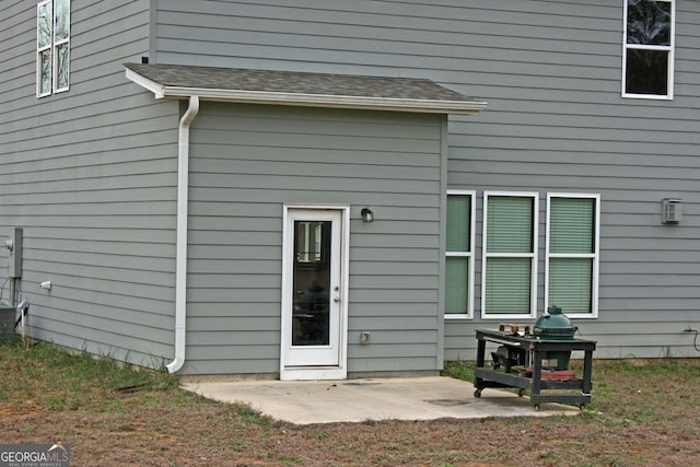 view of exterior entry with a patio