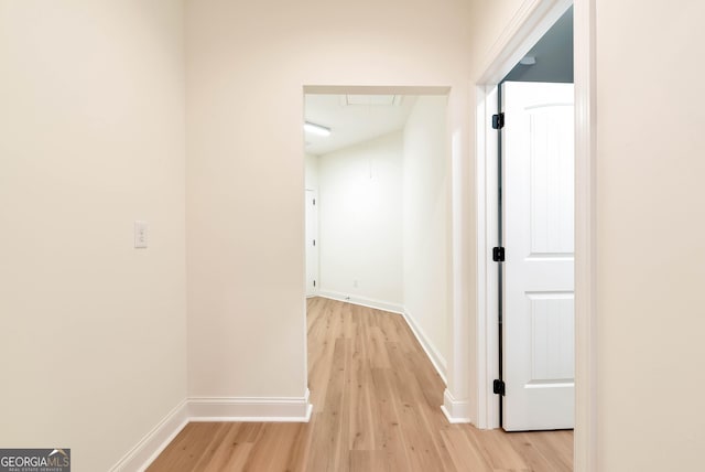 corridor with light hardwood / wood-style flooring