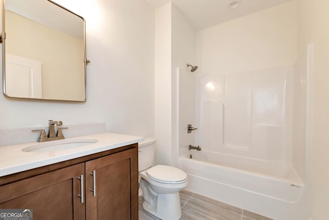 full bathroom featuring vanity, toilet, and washtub / shower combination