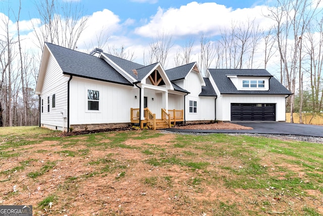 modern inspired farmhouse featuring a front yard and a garage