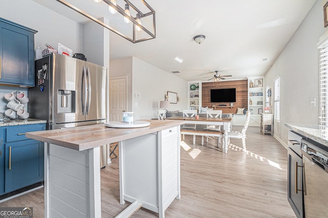 kitchen featuring blue cabinetry, a kitchen bar, light hardwood / wood-style flooring, dishwashing machine, and a kitchen island