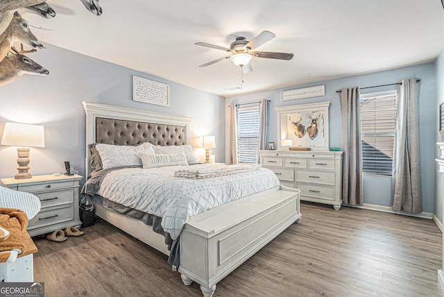 bedroom with ceiling fan and dark hardwood / wood-style flooring