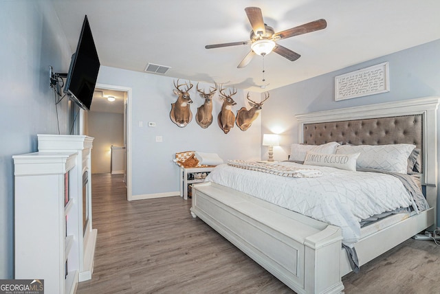 bedroom with hardwood / wood-style flooring and ceiling fan