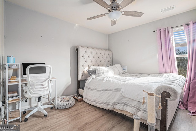 bedroom featuring wood-type flooring and ceiling fan