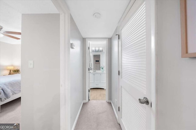 hallway featuring light colored carpet