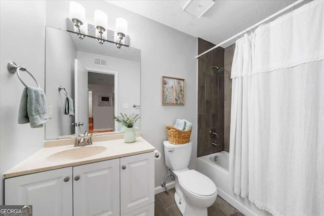 full bathroom with vanity, hardwood / wood-style flooring, toilet, a textured ceiling, and shower / tub combo with curtain