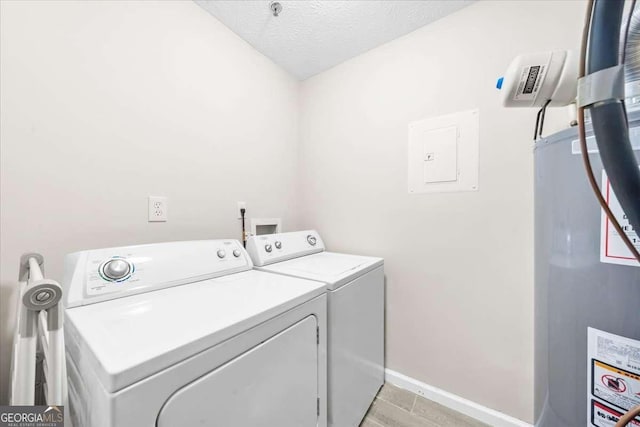 laundry area featuring gas water heater, separate washer and dryer, a textured ceiling, and electric panel