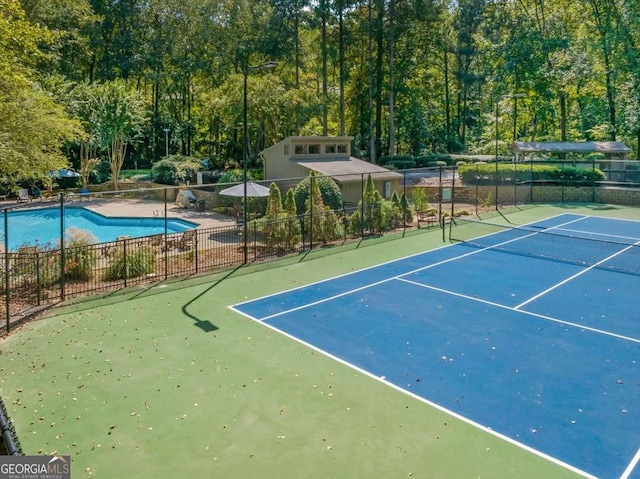 view of sport court with basketball hoop