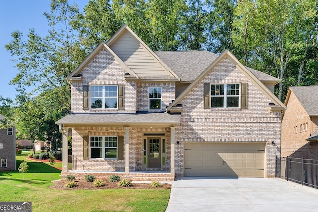 view of front of property featuring a porch, a garage, and a front lawn