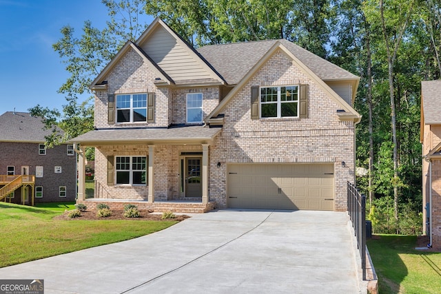 view of front of house with a porch, a garage, and a front lawn