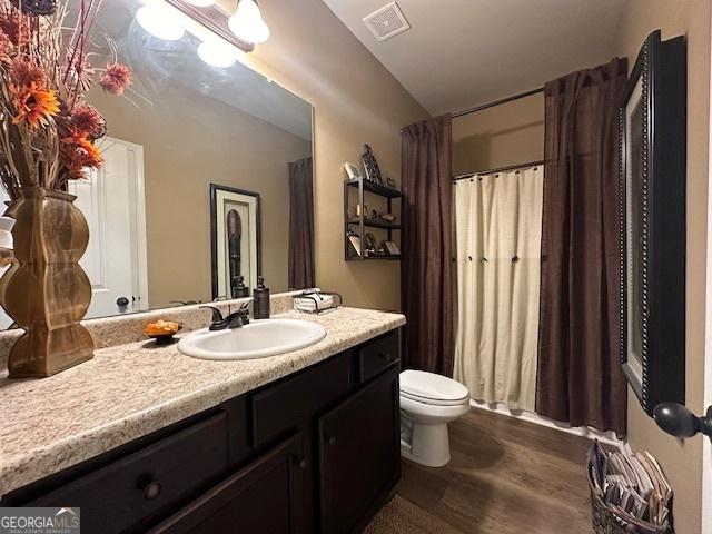 bathroom featuring hardwood / wood-style floors, vanity, and toilet