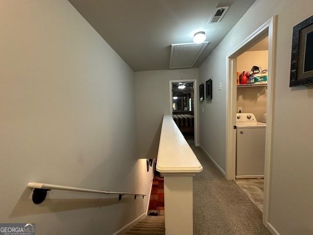 hallway featuring carpet flooring and washing machine and dryer