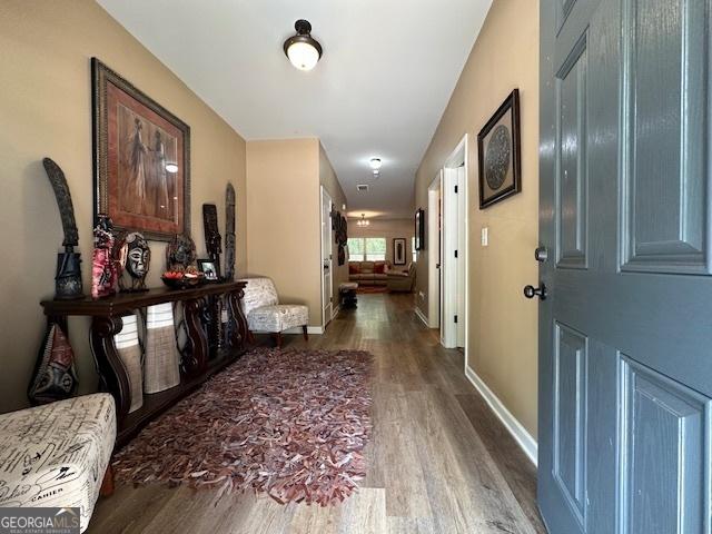 hall with hardwood / wood-style floors