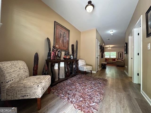 sitting room featuring dark wood-type flooring