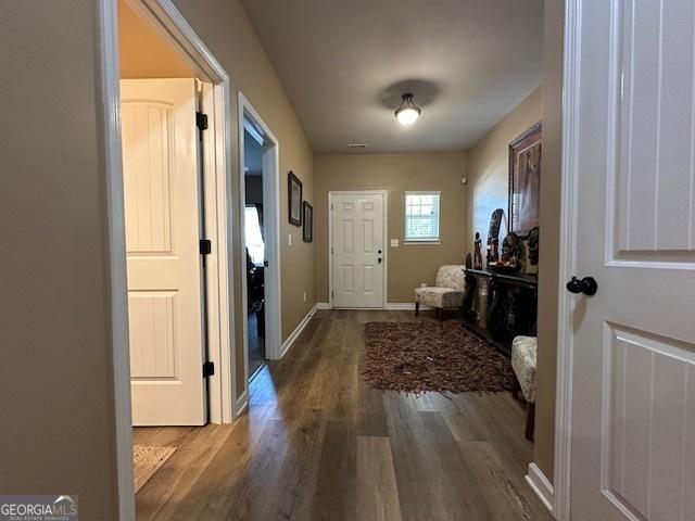 entryway with dark wood-type flooring