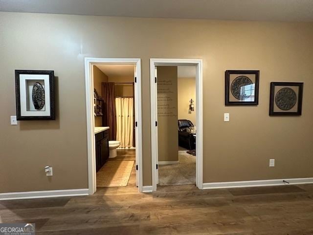 corridor with dark hardwood / wood-style floors