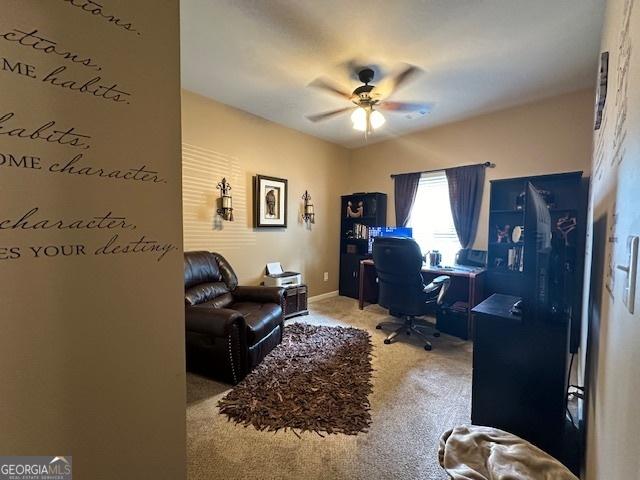 carpeted home office with ceiling fan