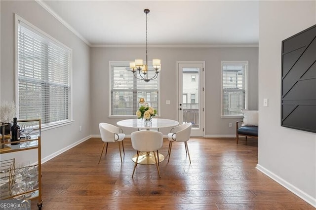 dining space featuring ornamental molding, a wealth of natural light, and an inviting chandelier