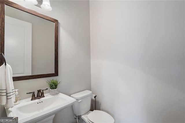 bathroom featuring sink and toilet