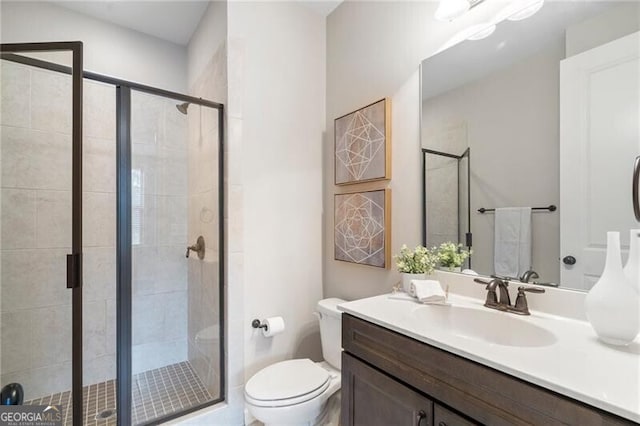 bathroom featuring vanity, toilet, and walk in shower