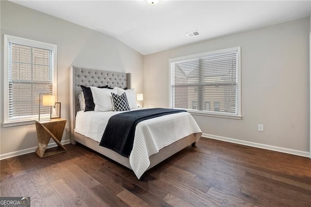 bedroom with dark wood-type flooring and vaulted ceiling