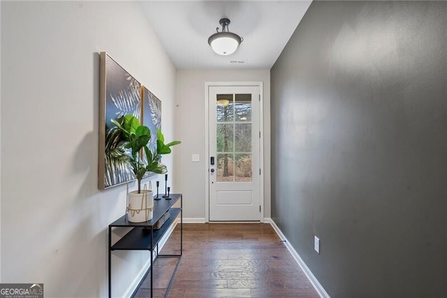 doorway featuring dark wood-type flooring