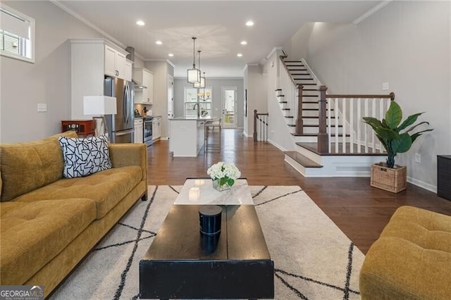 living room featuring dark wood-type flooring and ornamental molding