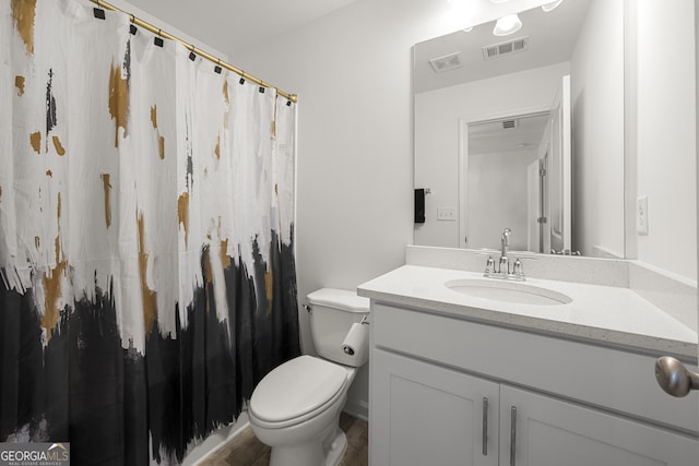 bathroom featuring vanity and toilet