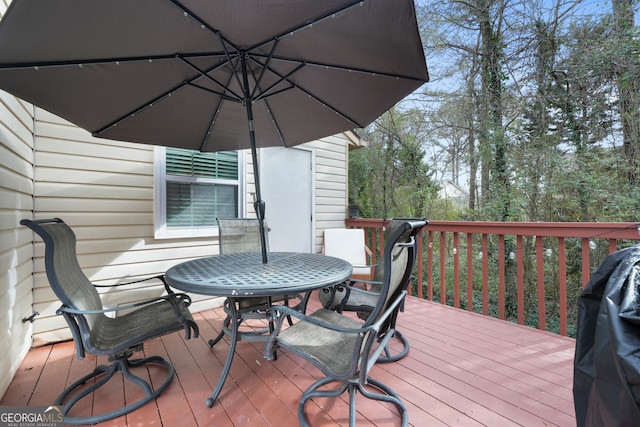 wooden terrace with a grill