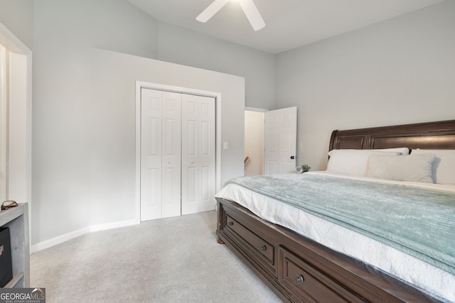 carpeted bedroom with ceiling fan and a closet