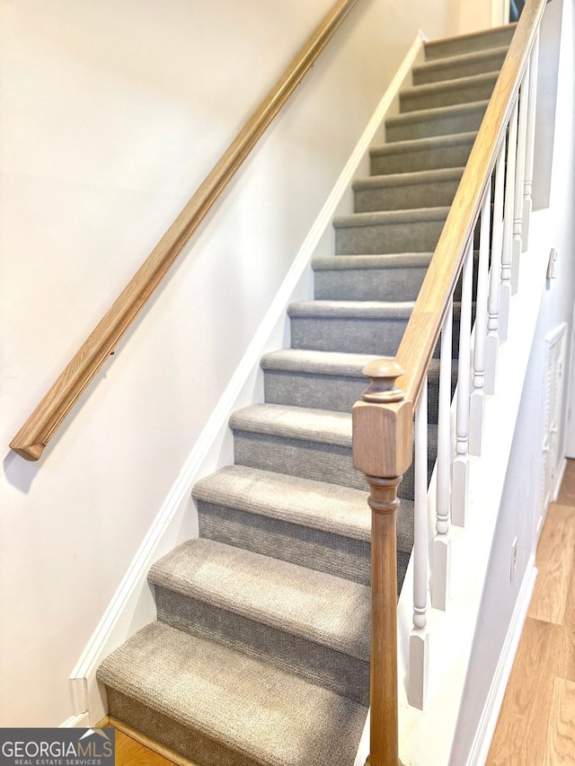 stairs with wood-type flooring