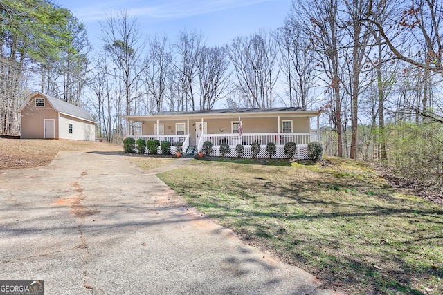 ranch-style home with driveway and a porch